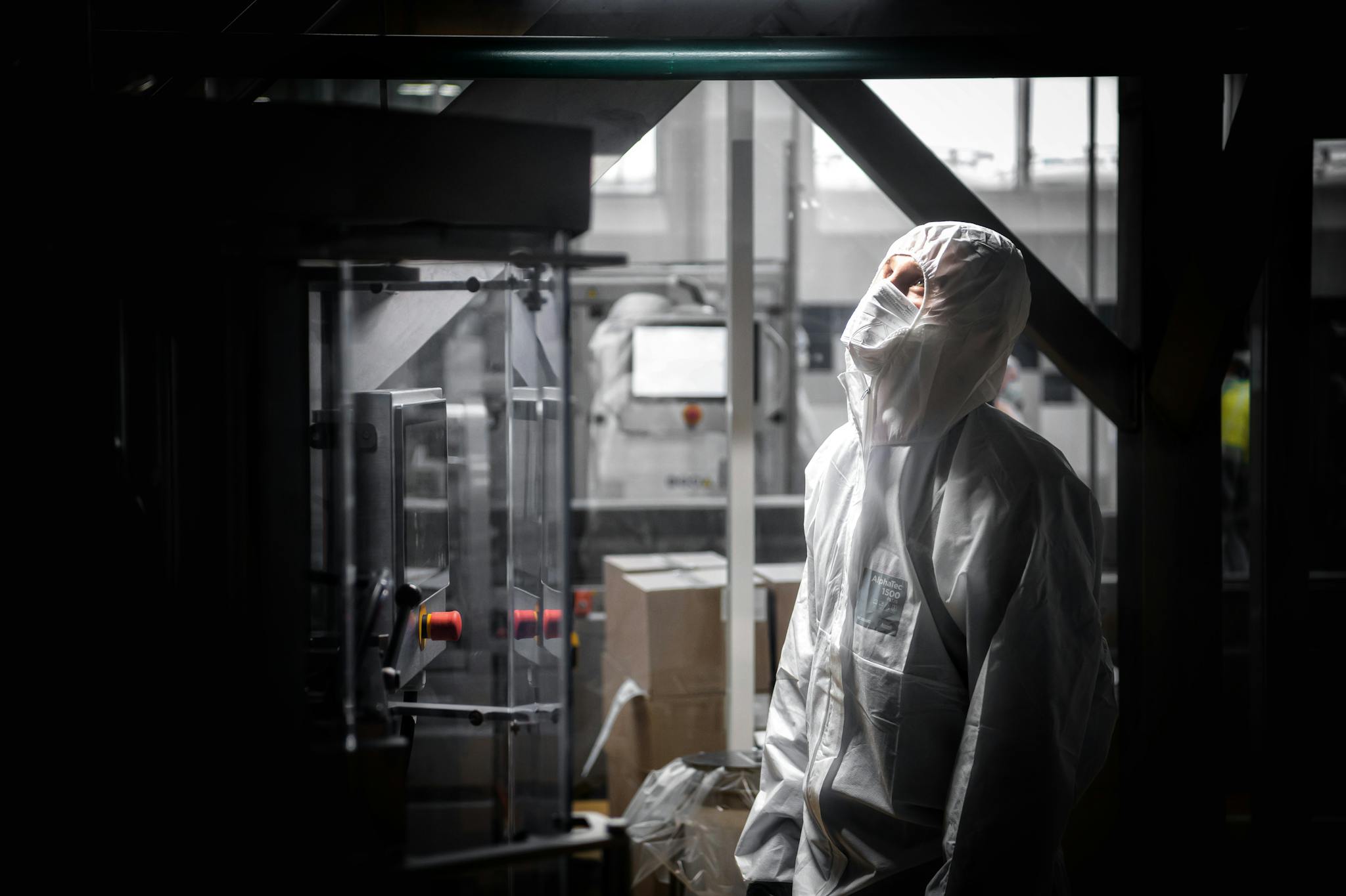 A man in protective gear works indoors at a factory in Moscow, Russia.